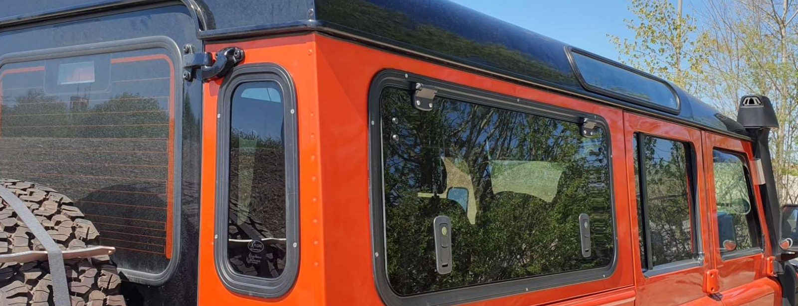Explore Glazing Land Rover Defender gullwing window dark grey glass.