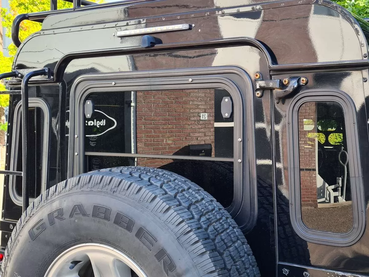 Explore Glazing Land Rover Defender halfdrop window taildoor and quarter windows.