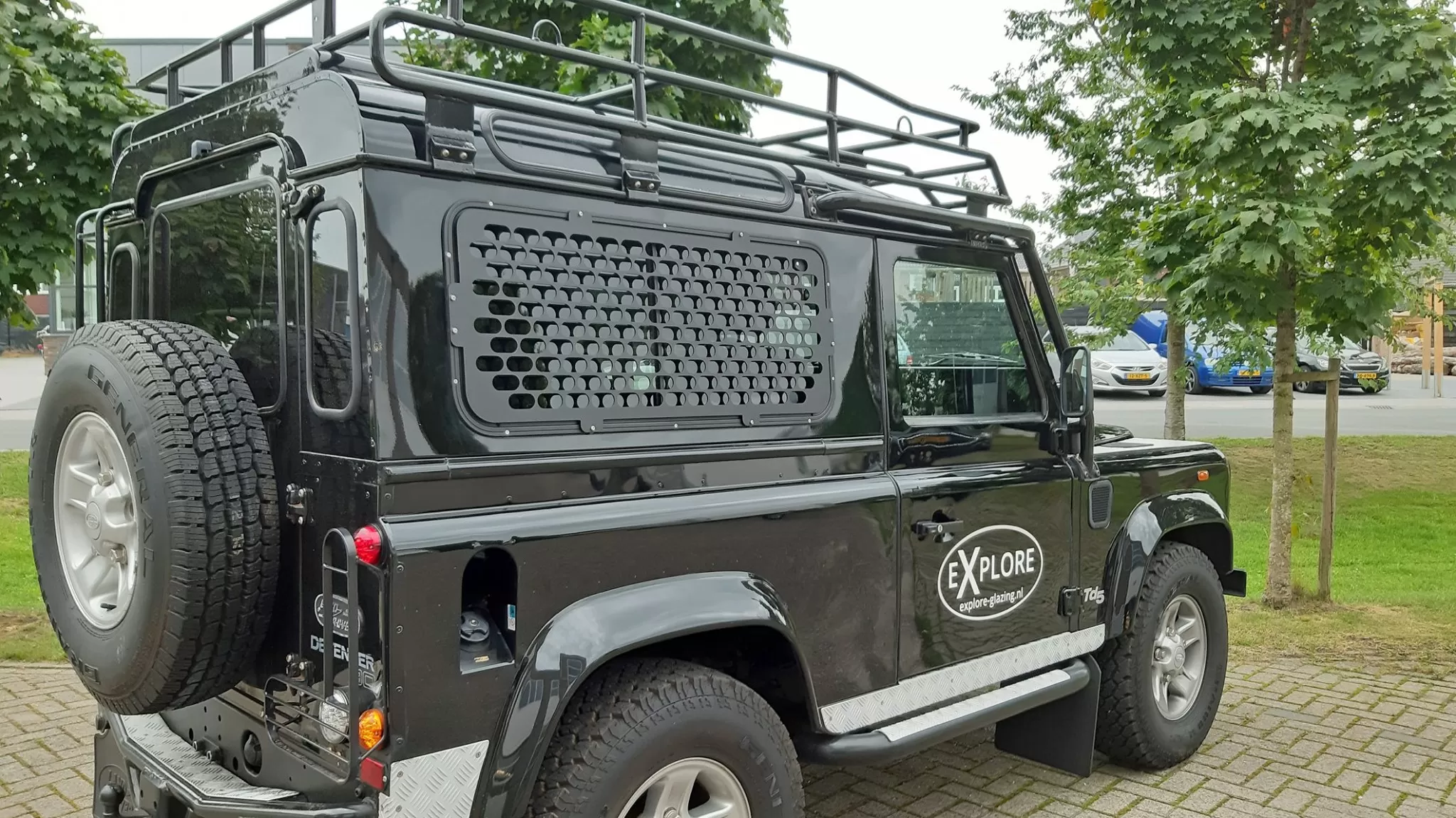 Explore Glazing Land Rover Defender sliding window with a window guard.
