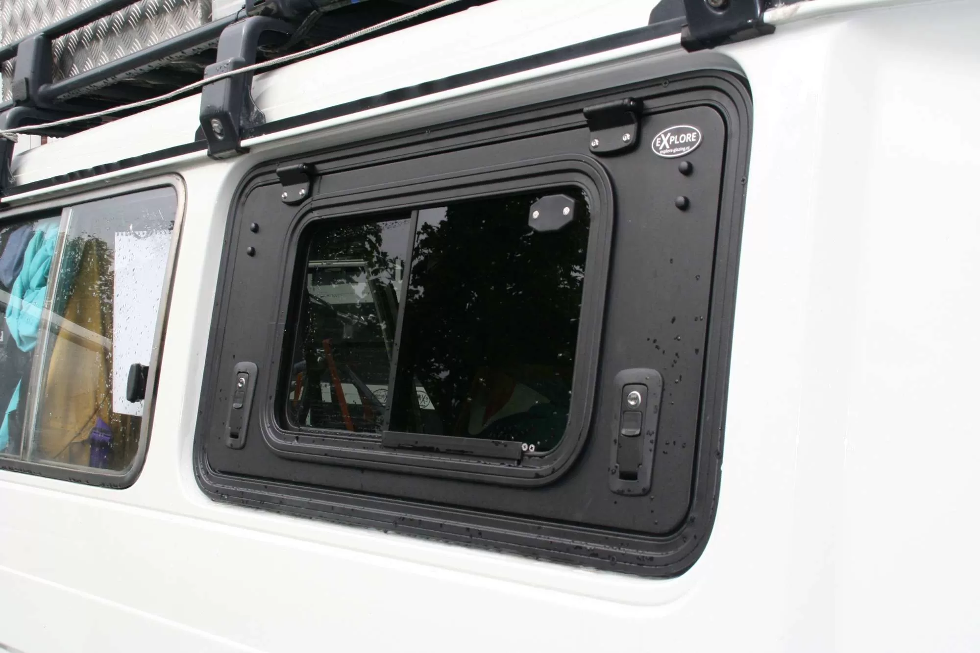 Toyota Troop Carrier with Explore Glazing gullwing window installed, showcasing functionality and design.