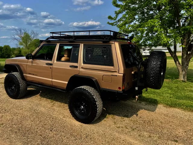 Explore Glazing Jeep Cherokee XJ 5-door gullwing window with a window guard