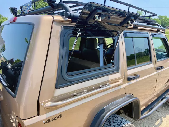 Explore Glazing Jeep Cherokee XJ 5-door gullwing window with a window guard