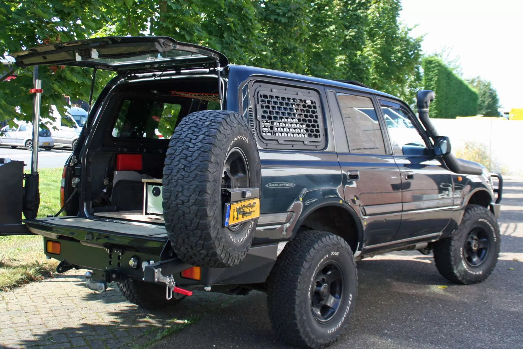 Toyota Land Cruiser 80 with sliding window and window guard.