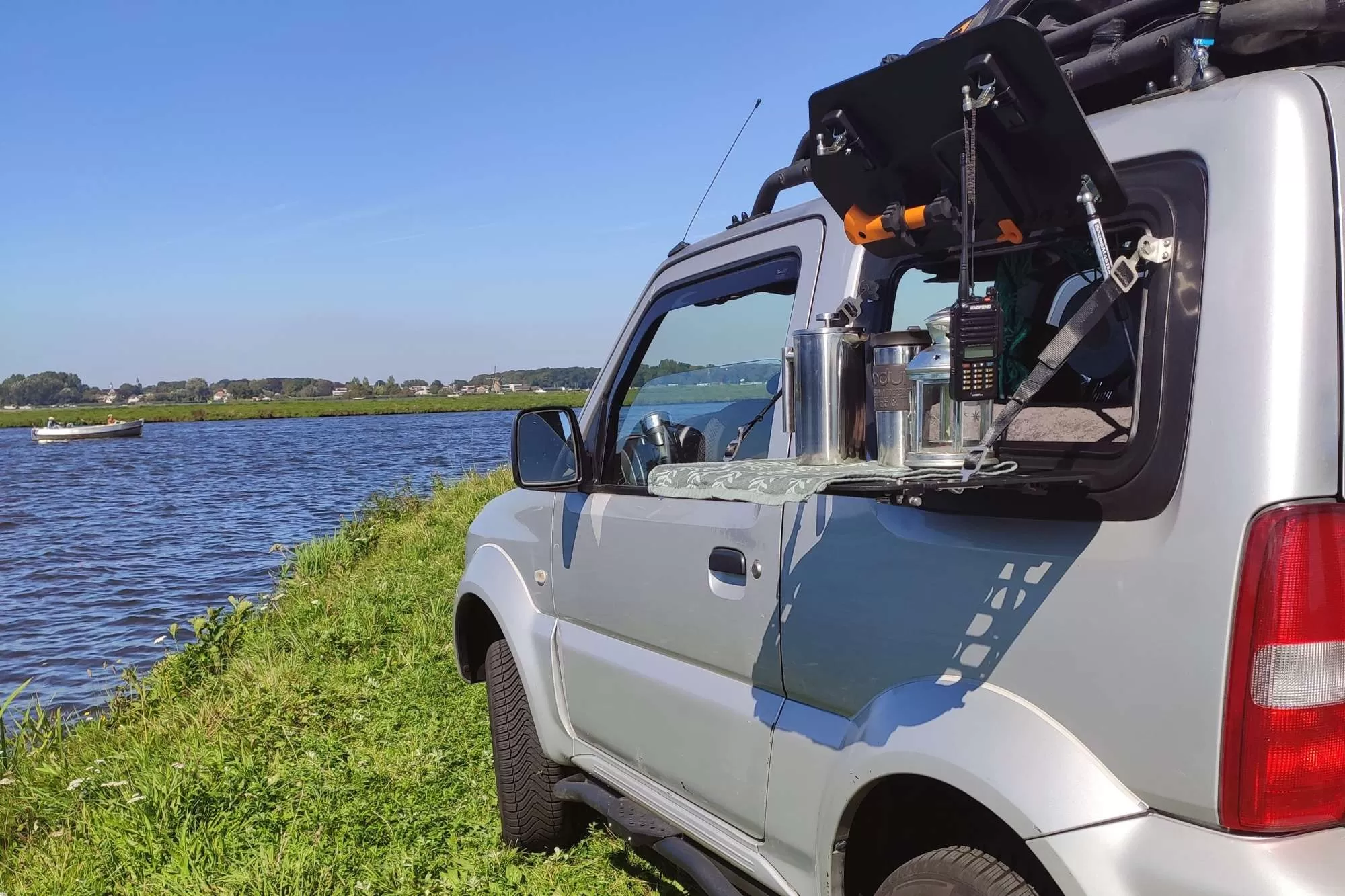 Suzuki Jimny FJ JB43 featuring a gullwing window and the Explore Overlander Light fold-down window guard/table.